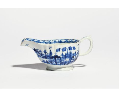 A Vauxhall blue and white sauceboat c.1756-62, of fluted form, painted with small huts beneath fringed trees in a Chinese isl