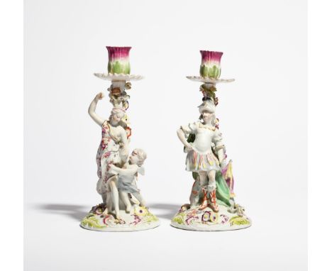 A pair of Derby candlestick figures of Venus and Mars  c.1760, each standing before a stump applied with colourful flowers, r