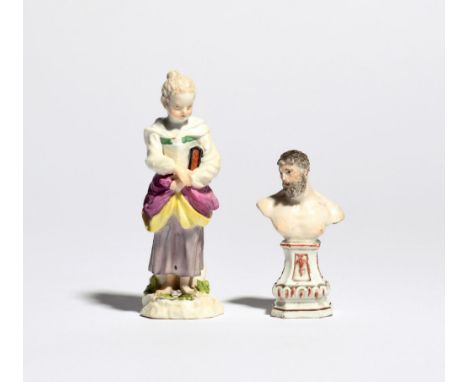 A Meissen figure of a student mid 18th century, modelled as a young girl clutching a large book under her left arm, and a Mei