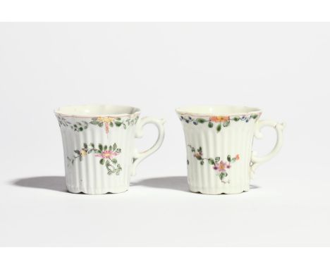 Two early Worcester coffee cups  c.1753-55, the reeded forms painted in famille verte enamels with sprays of flowering plants