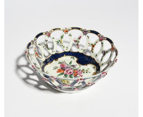 A Worcester circular basket c.1760-72, finely painted to the interior with an arrangement of flowers within a shaped blue sca