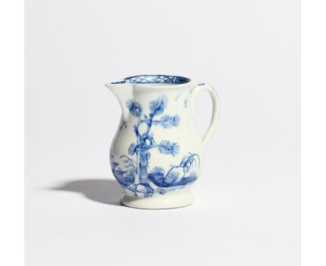 A Vauxhall blue and white milk jug c.1758-60, painted with a tall pine tree beside a two-storeyed pagoda on a rocky outcrop, 