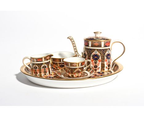 A miniature Royal Crown Derby solitaire tea service  modern, richly decorated in a panelled Imari pattern. Comprising: an ova