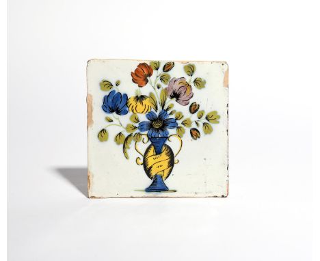 A Liverpool delftware tile  c.1760, boldly painted in the Fazackerly palette with flowers issuing from a curious yellow and b