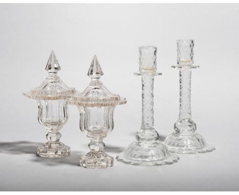 A pair of cut glass candlesticks,  late 18th/early 19th century, cut with small diamond facets and raised on tall domed bases