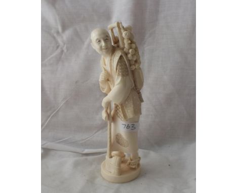 Carved figure of man with axe and haversack of faggots    