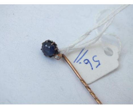 Gold stick pin set with a sapphire and small diamond   