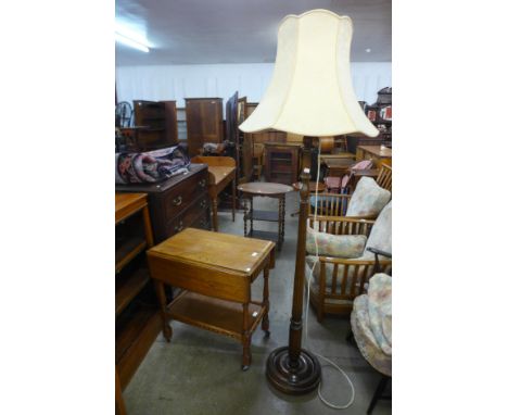An oak drop leaf trolley and an oak standard lamp 