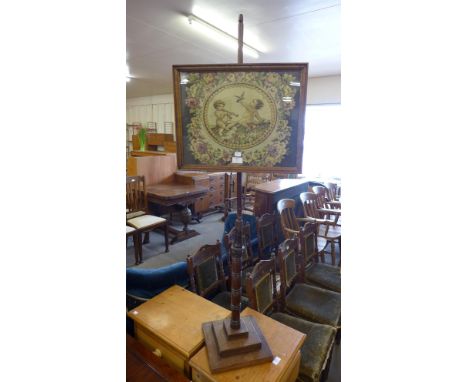 An early 20th Century mahogany pole screen 