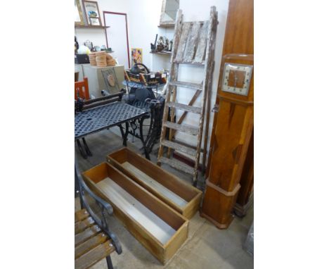 A pair of teak planters and a set of step ladders 