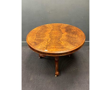 A Victorian burr walnut oval breakfast table on moulded tripod base with porcelain casters, circa 1860, 135cm long approx