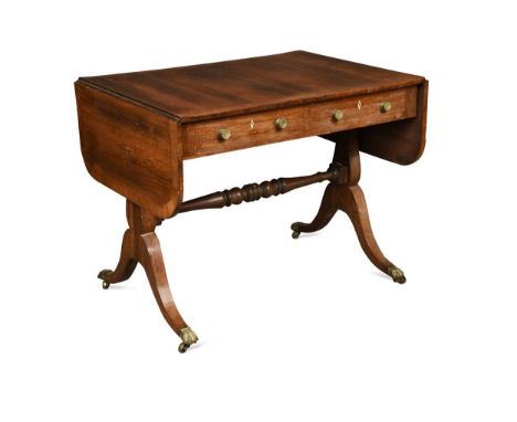 A Regency rosewood and crossbanded sofa table, fitted with two real and two opposing dummy drawers on splayed legs with brass