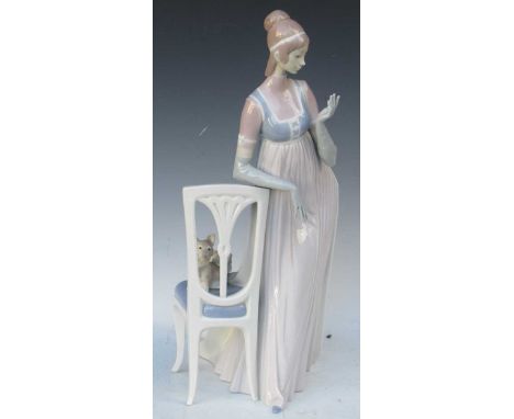 "Lady Empire" a large Lladro figure, standing with elbow on the back of a chair, her pet cat on the seat. 49cm HighImportant 