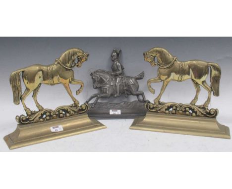 A pair of brass and door stops modelled as horses, together with as single spelter doorstop of a mounted guardsman (3)please 