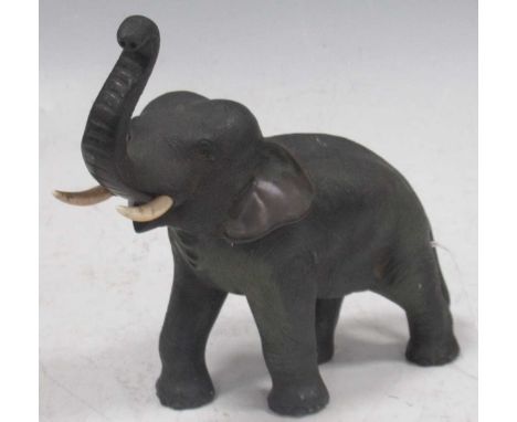 A Japanese bronze figure of a bull elephant, circa 1910-20 with trunk raised, ivory tusks, seal mark on belly, 18cm high