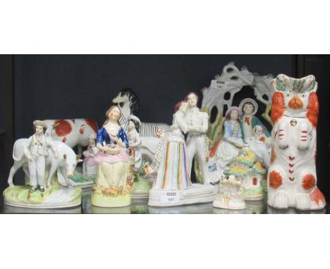 A collection of Staffordshire and other ceramic wares,to include a couple with their dog in a wooded bower, a pair of figures