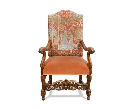 A Baroque style walnut and beech armchair, early 20th century, the arched rectangular top covered in needlepoint tapestry, wi
