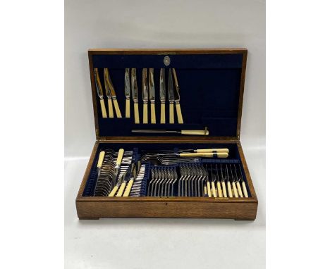 An oak canteen of silver plated flatware by Mappin &amp; Webb, containing eight place settings, including carving knife and f