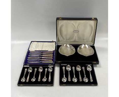 A small collection of Indian metalwares items comprising a cased set of 6 teaspoons and a cased set of 6 coffee spoons, each 