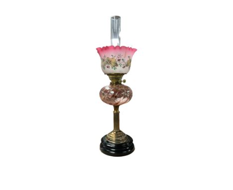Brass and glass mounted columnar table oil lamp, with pink glass reservoir upon a stepped circular base, H66cm 