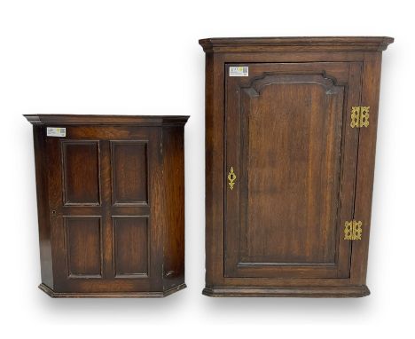 Early 20th century wall mounted oak corner cabinet, moulded cornice over panelled door enclosing single fixed shelf (W60cm, D