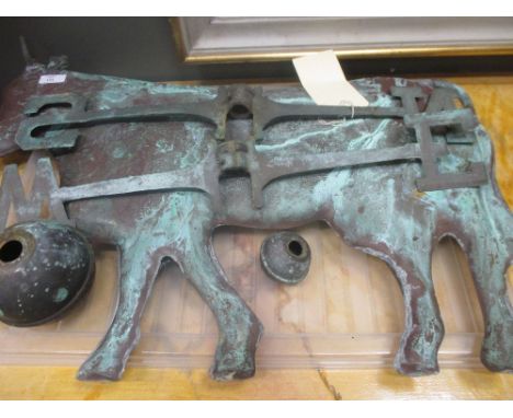 A copper weather vane modelled as a cow  