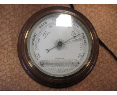 An Edwardian mahogany and brass mounted aneroid barometer with thermometer  