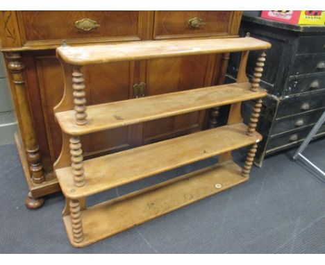 A mid 19th century continental four tier graduated wall shelf with bobbin supports 85 x 113 x 20cm  