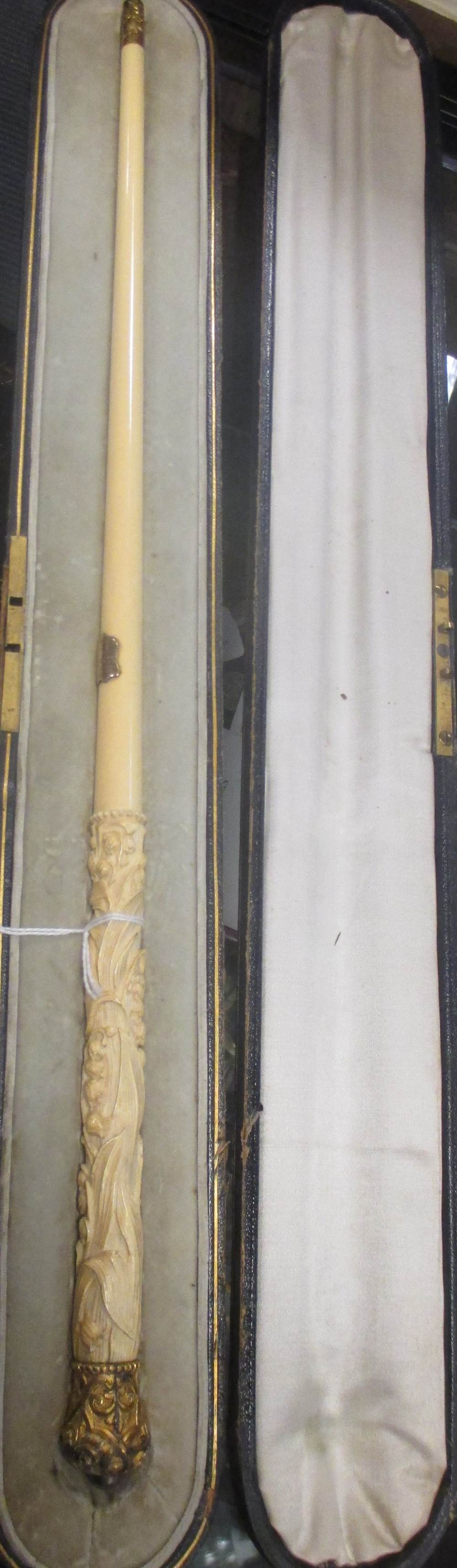 A late 19th century ivory conductor's baton with carved lily of the