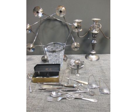 A collection of silver plated ware including two candelabra, flatware, game skewer, marrow scoop, ice bucket, sugar tongs etc