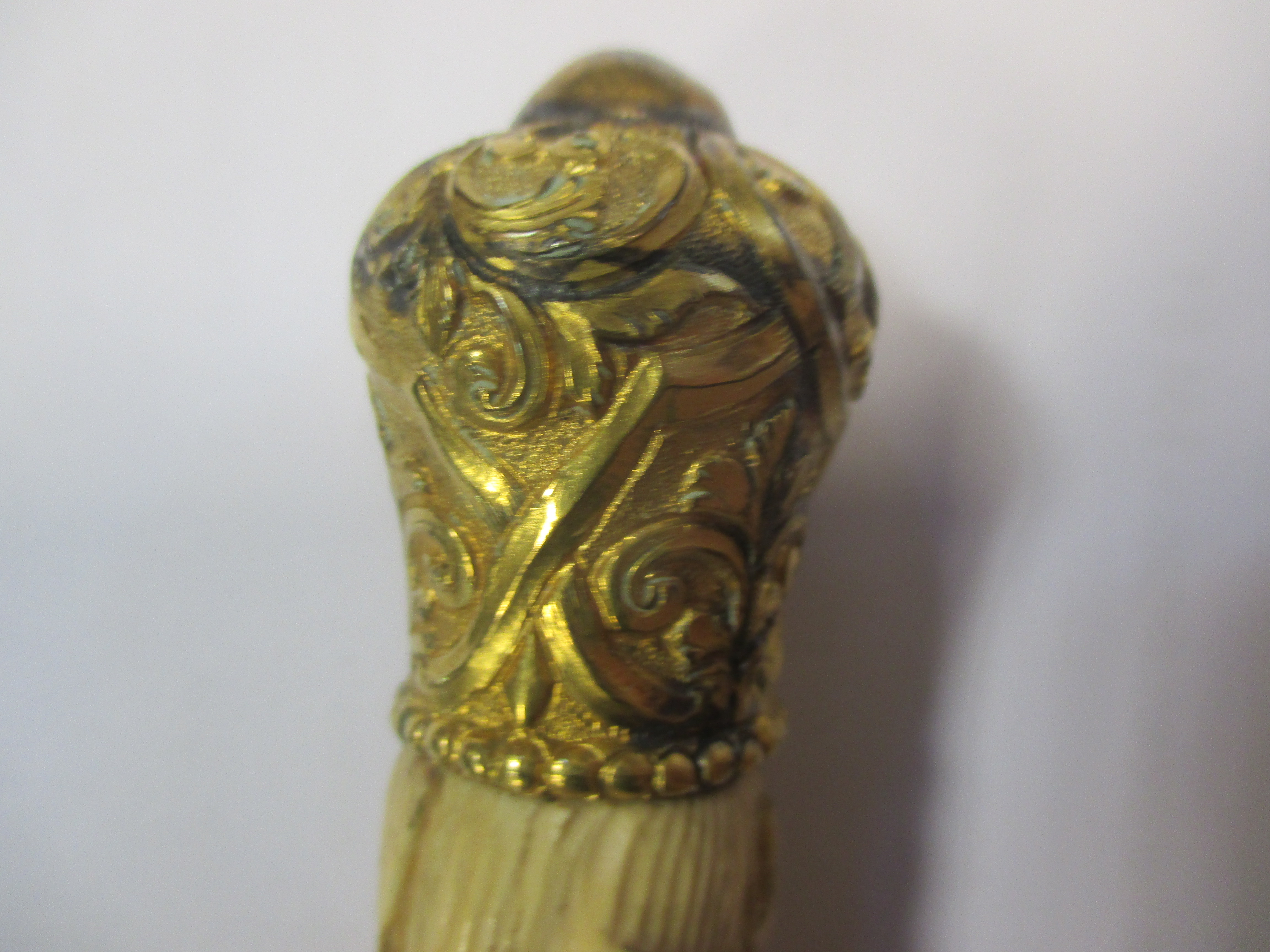 A late 19th century ivory conductor's baton with carved lily of the