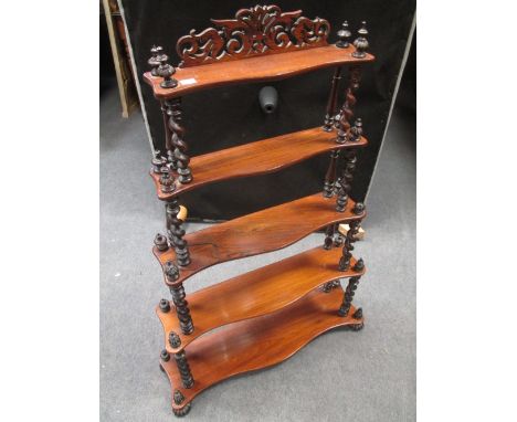 A Victorian rosewood three tier graduated shelf with twist turned supports, 105cm x 71 cm wide (the bottom shelf)  