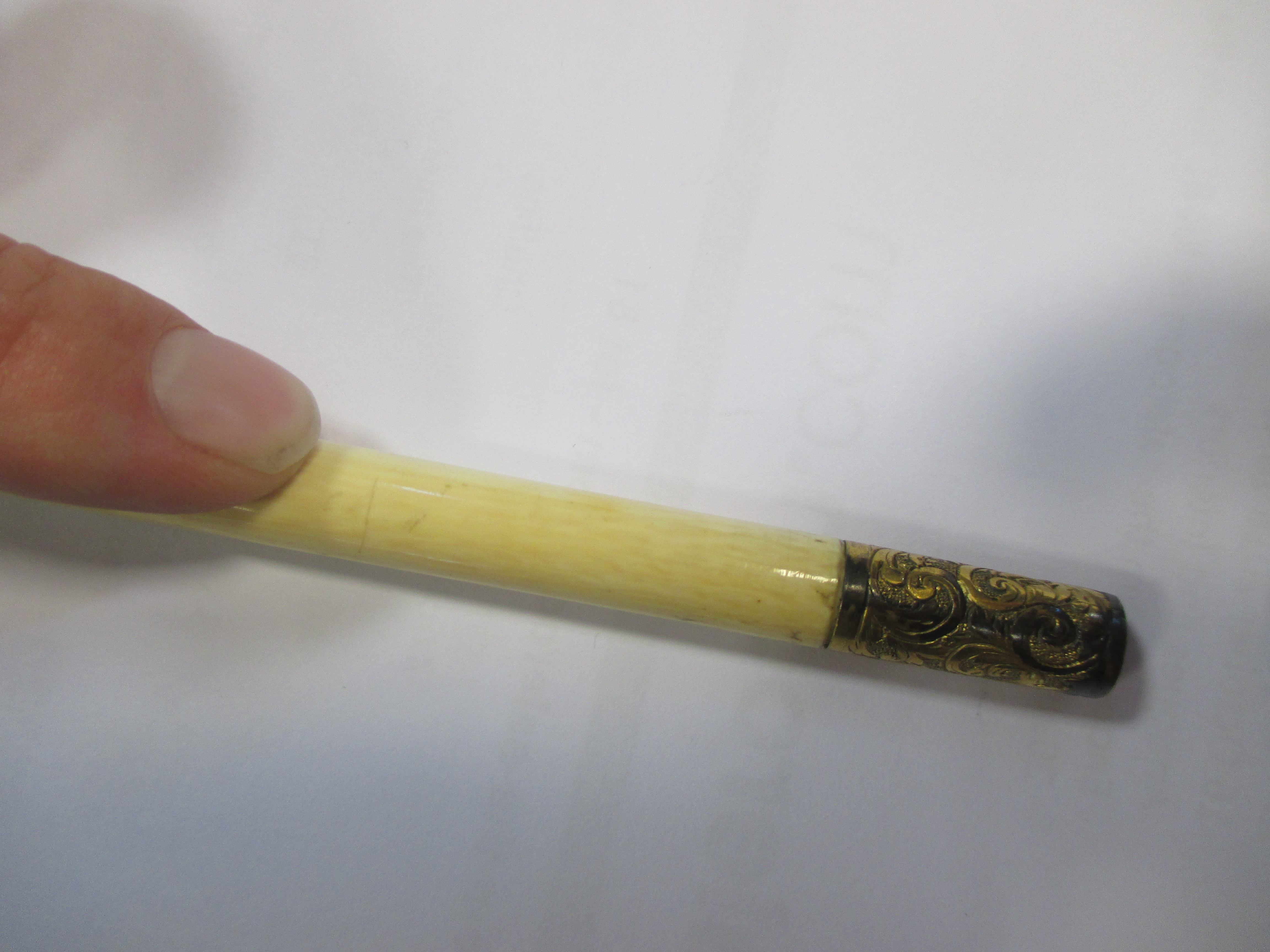 A late 19th century ivory conductor's baton with carved lily of the
