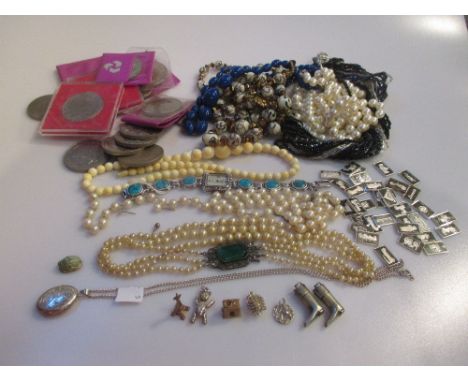 An ivory bead necklace together with a hallmarked silver locket, a quantity of costume jewellery, bead necklaces, charms (inc