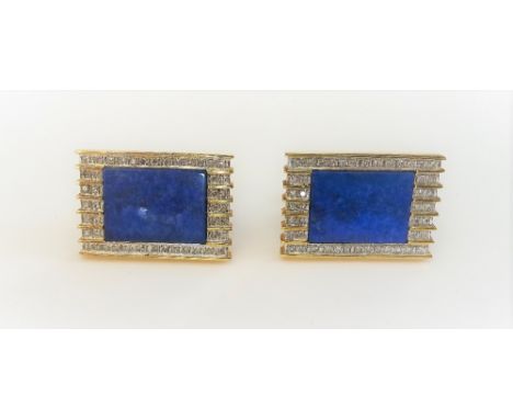 A pair of gold and lapis lazuli rectangular cufflinks, each mounted with a central lapis lazuli rectangular panel, in a surro