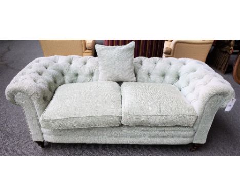 An early 20th century pale teal button back Chesterfield sofa, on bun feet, 180cm wide x 72cm high.