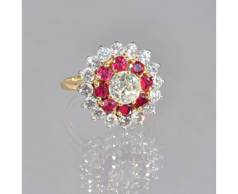 An 18ct gold, diamond and ruby cluster ring, claw set with the principal cushion shaped diamond at the centre, in a surround 