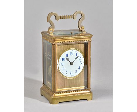 A FRENCH BRASS PETITE SONNERIE CARRIAGE CLOCKCirca 1900In a stylised Corniche case with shaped handle, the engine-turned gilt