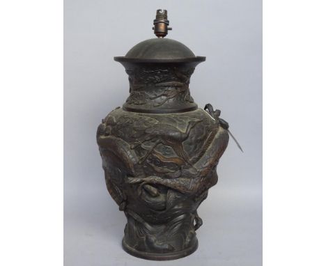 A Japanese mixed metal vase, relief cast with dragon chasing a flaming pearl, later converted to a table lamp base, 50cm high