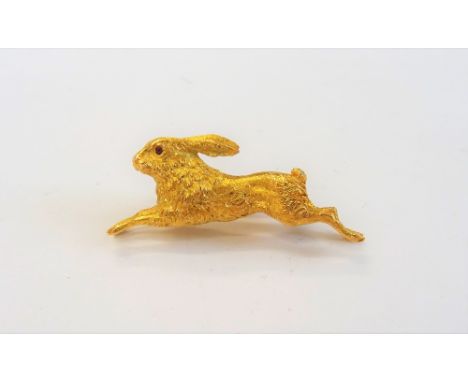 A 14ct gold brooch, designed as a running hare, with cabochon ruby set .eyes, import mark London possibly 1972, gross weight 