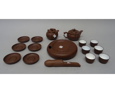 A Chinese Yixing stoneware tea service, 20th century, including a lotus moulded lidded teapot and jug with butterfly knops, a