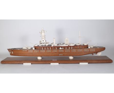 An oak and ivory mounted scale model of a war ship, circa. 1900, raised on a chamfered oak plinth and six ivory feet, 100cm w