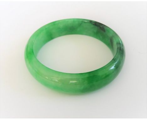 A jadeite jade bangle, the exterior domed, the interior flat, size 7.03 mm deep x 15.40mm wide and 57 mm inside diameter, wei