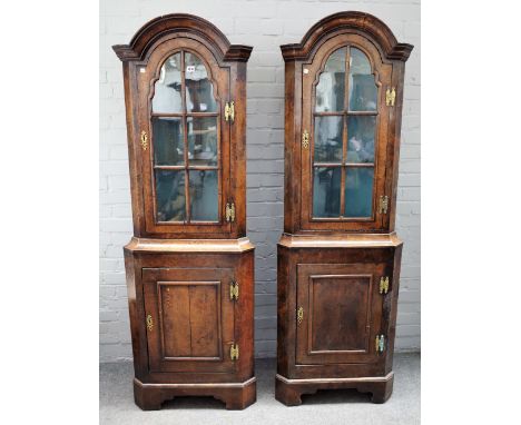 A pair of 18th century style figured walnut corner display cabinet/cupboards, the bonnet top over single glazed door and pane