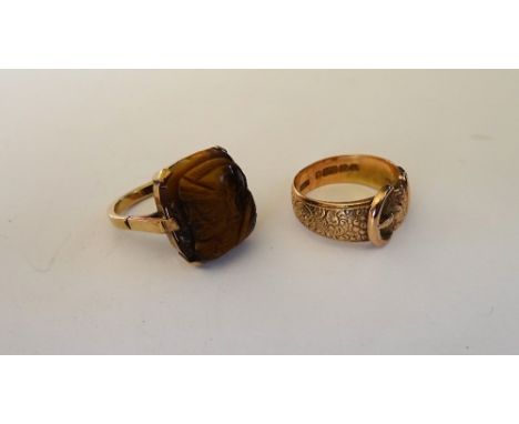 A 9ct gold ring, in a buckle and strap design, having scrolling decoration, Birmingham 1903, ring size O, weight 4.9 gms and 