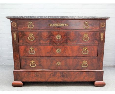 A 19th century French commode, the marble top on a gilt metal mounted mahogany base of five long graduated drawers on ogee fe