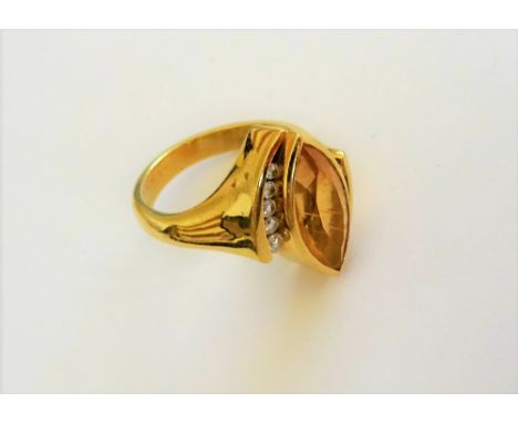 An 18ct gold, citrine and diamond ring, mounted with the marquise shaped citrine between two rows of five circular cut diamon