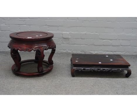 A Chinese hardwood circular stand, 20th century, carved with bats above five cabriole legs and a halo stretcher, 36cm. high; 