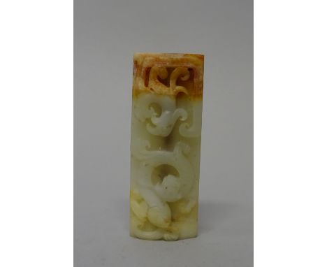 A Chinese jade rectangular bead, probably Han dynasty, carved with a dragon and phoenix, the reverse carved with scrolls, the