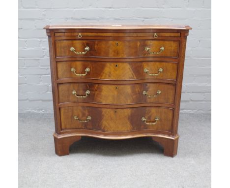 An early 19th century mahogany serpentine chest, the brushing slide over four long graduated drawers on bracket feet, 82cm wi
